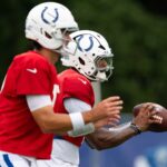 Indianapolis Colts quarterbacks Anthony Richardson Sr. (5) and Daniel Jones (17) drop back to pass Monday, July 28, 2025, during training camp held at Grand Park in Westfield.
