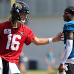 Jacksonville Jaguars quarterback Trevor Lawrence (16) talks technique with wide receiver Travis Hunter (12) after an NFL training camp session at the Miller Electric Center, Sunday, Aug. 3, 2025, in Jacksonville, Fla. [Corey Perrine/Florida Times-Union]