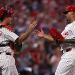 Aug 3, 2025; Philadelphia, Pennsylvania, USA; Philadelphia Phillies pitcher Jhoan Duran (59) and catcher J.T. Realmuto (10) shake hands after a victory against the Detroit Tigers at Citizens Bank Park. Mandatory Credit: Bill Streicher-Imagn Images