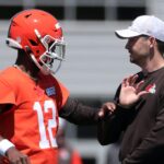Browns quarterback Shedeur Sanders works with offensive coordinator Tommy Rees during rookie minicamp May 9, 2025, in Berea.