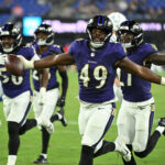 Aug 7, 2025; Baltimore, Maryland, USA; Baltimore Ravens linebacker Jay Higgins IV (49) celebrates after an interception against the Indianapolis Colts during the fourth quarter at M&T Bank Stadium. Mandatory Credit: Rafael Suanes-Imagn Images