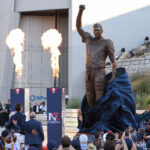 Aug 8, 2025; Foxborough, Massachusetts, USA; Retired New England Patriot Hall of Famer Tom Brady stands with Jonathan and Robert Kraft during a statue unveiling before a game against the Washington Commanders at Gillette Stadium.