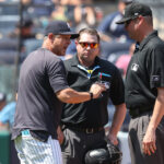 Aug 10, 2025; Bronx, New York, USA; New York Yankees manager Aaron Boone (17) argues with umpires Derek Thomas (53) and Jordan Baker (71) in the third inning against the Houston Astros at Yankee Stadium. Mandatory Credit: Wendell Cruz-Imagn Images