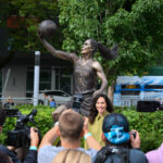 Aug 17, 2025; Seattle, Washington, USA; Former Seattle Storm player, Sue Bird, poses for a photo in front of her statue prior to the game between the Seattle Storm and the Phoenix Mercury at Climate Pledge Arena.
