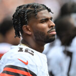 Aug 23, 2025; Cleveland, Ohio, USA; Cleveland Browns quarterback Shedeur Sanders (12) listens to the national anthem before the game between the Browns and the Los Angeles Rams at Huntington Bank Field.