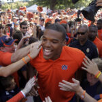 Oct 23, 2010; Auburn, AL, USA; Auburn Tigers quarterback Cameron Newton walks through Tigers Walk prior to the game against the LSU Tigers at Jordan Hare Stadium in Auburn. Mandatory Credit: John Reed-USA TODAY Sports