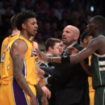 Mar 17, 2017; Los Angeles, CA, USA; Los Angeles Lakers guard Nick Young (0) is restrained by Milwaukee Bucks coach Jason Kidd (center) and guard Tony Snell (right) during a NBA basketball game at the Staples Center. The Bucks defeated the Lakers 107-103.