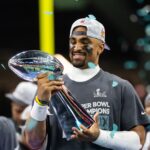 Feb 9, 2025; New Orleans, LA, USA; Philadelphia Eagles quarterback Jalen Hurts (1) celebrates with the Vince Lombardi Trophy after defeating the Kansas City Chiefs during Super Bowl LIX at Ceasars Superdome.