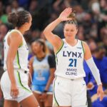 Jul 22, 2025; Minneapolis, Minnesota, USA; Minnesota Lynx guard Kayla McBride (21) celebrates with forward Napheesa Collier (24) against the Chicago Sky at the end of the second quarter at Target Center.