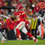 Aug 22, 2025; Kansas City, Missouri, USA; Kansas City Chiefs quarterback Patrick Mahomes (15) runs the ball against Chicago Bears cornerback Nahshon Wright (25) and linebacker Ruben Hyppolite II (47) during the first half at GEHA Field at Arrowhead Stadium.