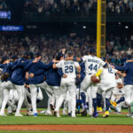 Sep 24, 2025; Seattle, Washington, USA; Seattle Mariners players and coaches celebrate after winning the American League West Division against the Colorado Rockies at T-Mobile Park. Mandatory Credit: Stephen Brashear-Imagn Images