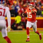 Nov 1, 2021; Kansas City, Missouri, USA; Kansas City Chiefs quarterback Patrick Mahomes (15) gestures as he runs with the ball as New York Giants outside linebacker Azeez Ojulari (51) defends during the second half at GEHA Field at Arrowhead Stadium.
