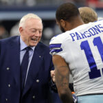 Jan 16, 2022; Arlington, Texas, USA; Dallas Cowboys owner Jerry Jones meets with outside linebacker Micah Parsons (11) prior to the NFC Wild Card playoff football game against the San Francisco 49ers at AT&T Stadium. Mandatory Credit: Kevin Jairaj-USA TODAY Sports