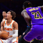 Jan 6, 2023; Los Angeles, California, USA; Atlanta Hawks guard Trae Young (11) moves to the basket agianst Los Angeles Lakers guard Patrick Beverley (21) during the first half at Crypto.com Arena.