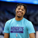 Mar 24, 2023; Dallas, Texas, USA; Charlotte Hornets guard Dennis Smith Jr. (8) laughs before the game against the Dallas Mavericks at American Airlines Center.