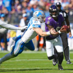 Oct 22, 2023; Baltimore, Maryland, USA; NFL; Baltimore Ravens quarterback Lamar Jackson (8) is tackled by Detroit Lions defensive lineman Aidan Hutchinson (97) during the first quarter at M&T Bank Stadium.