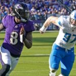 Oct 22, 2023; Baltimore, Maryland, USA; Baltimore Ravens quarterback Lamar Jackson (8) is pressured by Detroit Lions defensive lineman Aidan Hutchinson (97) during the fourth quarter at M&T Bank Stadium.