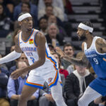 Nov 28, 2023; Minneapolis, Minnesota, USA; Oklahoma City Thunder guard Shai Gilgeous-Alexander (2) looks to pass around Minnesota Timberwolves guard Nickeil Alexander-Walker (9) in the second half at Target Center. Mandatory Credit: Jesse Johnson-USA TODAY Sports