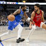 Jan 13, 2024; Dallas, Texas, USA; Dallas Mavericks guard Kyrie Irving (11) and New Orleans Pelicans forward Jeremiah Robinson-Earl (50) in action during the game between the Dallas Mavericks and the New Orleans Pelicans at the American Airlines Center.