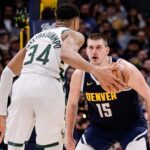 Jan 29, 2024; Denver, Colorado, USA; Milwaukee Bucks forward Giannis Antetokounmpo (34) controls the ball as Denver Nuggets center Nikola Jokic (15) guards in the fourth quarter at Ball Arena.