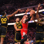 Mar 7, 2024; San Francisco, California, USA; Chicago Bulls forward Alex Caruso (6) drives in between Golden State Warriors forward Jonathan Kuminga (00), guard Stephen Curry (30), and forward Draymond Green (23) during the third quarter at Chase Center.