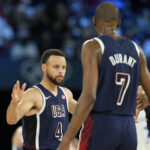 Aug 10, 2024; Paris, France; United States shooting guard Stephen Curry (4) and guard Kevin Durant (7) react in the second half against France in the men's basketball gold medal game during the Paris 2024 Olympic Summer Games at Accor Arena. Mandatory Credit: Kyle Terada-USA TODAY Sports