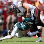 Sep 29, 2024; Tampa, Florida, USA; Tampa Bay Buccaneers quarterback Baker Mayfield (6) scores a touchdown past Philadelphia Eagles safety Reed Blankenship (32) in the second quarter at Raymond James Stadium.