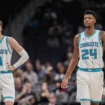 Oct 8, 2024; Charlotte, North Carolina, USA; Charlotte Hornets guard LaMelo Ball (1) and forward Brandon Miller (24) at mid court against the Miami Heat during the second half at Spectrum Center.