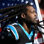 Nov 24, 2024; Charlotte, North Carolina, USA; Carolina Panthers linebacker Jadeveon Clowney (7) runs on to the field with the american flag before the game at Bank of America Stadium. Mandatory Credit: Bob Donnan-Imagn Images