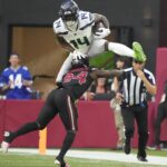 NFL; Seattle Seahawks wide receiver DK Metcalf (14) jumps over Arizona Cardinals cornerback Starling Thomas V (24) during the second quarter at State Farm Stadium in Glendale on Dec. 8, 2024.