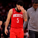 Dec 29, 2024; Houston, Texas, USA; Houston Rockets guard Fred VanVleet (5) is escorted off the court after being ejected against the Miami Heat during the fourth quarter at Toyota Center.