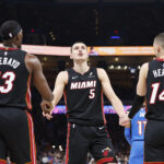 Feb 12, 2025; Oklahoma City, Oklahoma, USA; Miami Heat forward Nikola Jovic (5) celebrates with teammates center Bam Adebayo (13) and guard Tyler Herro (14) after a play against the Oklahoma City Thunder during the second quarter at Paycom Center. Mandatory Credit: Alonzo Adams-Imagn Images