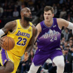 Feb 12, 2025; Salt Lake City, Utah, USA; Los Angeles Lakers forward LeBron James (23) dribbles past Utah Jazz center Walker Kessler (24) during the first quarter at Delta Center.