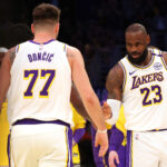 Mar 2, 2025; Los Angeles, California, USA; Los Angeles Lakers forward LeBron James (23) and guard Luka Doncic (77) react after a play during the first quarter against the LA Clippers at Crypto.com Arena. Mandatory Credit: Jason Parkhurst-Imagn Images
