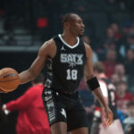 Portland, Oregon, USA; San Antonio Spurs center Bismack Biyombo (18) controls the ball during the first half against the Portland Trail Blazers at Moda Center. Mandatory Credit: Soobum Im-Imagn Images