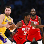 Apr 11, 2025; Los Angeles, California, USA; Los Angeles Lakers guard Luka Doncic (77) looks to pass against Houston Rockets guard Nate Williams (19) during the second half at Crypto.com Arena.
