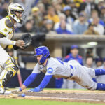 Apr 15, 2025; San Diego, California, USA; Chicago Cubs shortstop Dansby Swanson (7) slides as he scores ahead of the throw to San Diego Padres catcher Martin Maldonado (15) during the sixth inning at Petco Park. Mandatory Credit: Denis Poroy-Imagn Images