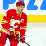 Apr 15, 2025; Calgary, Alberta, CAN; Calgary Flames center Mikael Backlund (11) skates during the warmup period against the Vegas Golden Knights at Scotiabank Saddledome. Mandatory Credit: Sergei Belski-Imagn Images