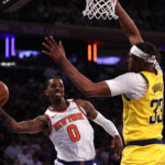 May 29, 2025; New York, New York, USA; New York Knicks guard Delon Wright (0) controls the ball against Indiana Pacers center Myles Turner (33) in the fourth quarter during game five of the eastern conference finals for the 2025 NBA Playoffs at Madison Square Garden.