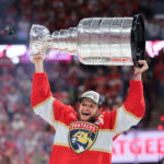 Jun 17, 2025; Sunrise, Florida, USA; Florida Panthers center Aleksander Barkov (16) hoists the Stanley Cup after winning game six of the 2025 Stanley Cup Final against the Edmonton Oilers at Amerant Bank Arena. Mandatory Credit: Sam Navarro-Imagn Images