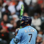 Aug 16, 2025; San Francisco, California, USA; Tampa Bay Rays shortstop Ha-Seong Kim (7) uses a special bat as part of MLB players weekend during the seventh inning against the San Francisco Giants at Oracle Park. Mandatory Credit: Darren Yamashita-Imagn Images