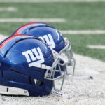 Aug 16, 2025; East Rutherford, New Jersey, USA; New York Giants helmets rest on the field before the preseason game against the New York Jets at MetLife Stadium. Mandatory Credit: Vincent Carchietta-Imagn Images