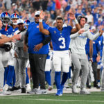 Aug 16, 2025; East Rutherford, New Jersey, USA; New York Giants quarterback Russell Wilson (3) gestures for a touchdown against the New York Jets during the second half at MetLife Stadium. Mandatory Credit: Rich Barnes-Imagn Images