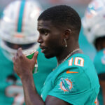 Aug 23, 2025; Miami Gardens, Florida, USA; Miami Dolphins wide receiver Tyreek Hill (10) watches from the sideline against the Jacksonville Jaguars during the first quarter at Hard Rock Stadium. Mandatory Credit: Sam Navarro-Imagn Images