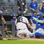 Sep 6, 2025; Bronx, New York, USA; New York Yankees catcher Austin Wells (28) tags out Toronto Blue Jays shortstop Bo Bichette (11) at home plate during the sixth inning at Yankee Stadium. Mandatory Credit: John Jones-Imagn Images