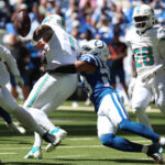 Xavien Howard Sep 7, 2025; Indianapolis, Indiana, USA; Indianapolis Colts cornerback Kenny Moore II (23) causes a fumble by Miami Dolphins quarterback Tua Tagovailoa (1) during the first half at Lucas Oil Stadium. Mandatory Credit: Trevor Ruszkowski-Imagn Images