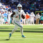 Sep 7, 2025; Indianapolis, Indiana, USA; Miami Dolphins quarterback Tua Tagovailoa (1) rolls out during the second half against the Indianapolis Colts at Lucas Oil Stadium. Mandatory Credit: Trevor Ruszkowski-Imagn Images