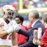 Sep 7, 2025; Seattle, Washington, USA; San Francisco 49ers defensive end Nick Bosa (97) reacts with San Francisco 49ers general manager John Lynch before the game against the Seattle Seahawks at Lumen Field. Mandatory Credit: Joe Nicholson-Imagn Images