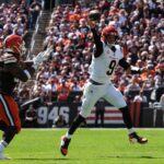 Bengals Joe Burrow (9) runs to avoid the Browns and throws during the game at Huntington Bank Field on Sunday, Sept. 7, 2025.