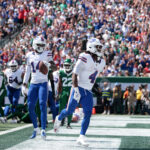 Sep 14, 2025; East Rutherford, New Jersey, USA; Buffalo Bills running back James Cook (4) reacts after scoring a touchdown against the New York Jets during the first half at MetLife Stadium. Mandatory Credit: Vincent Carchietta-Imagn Images